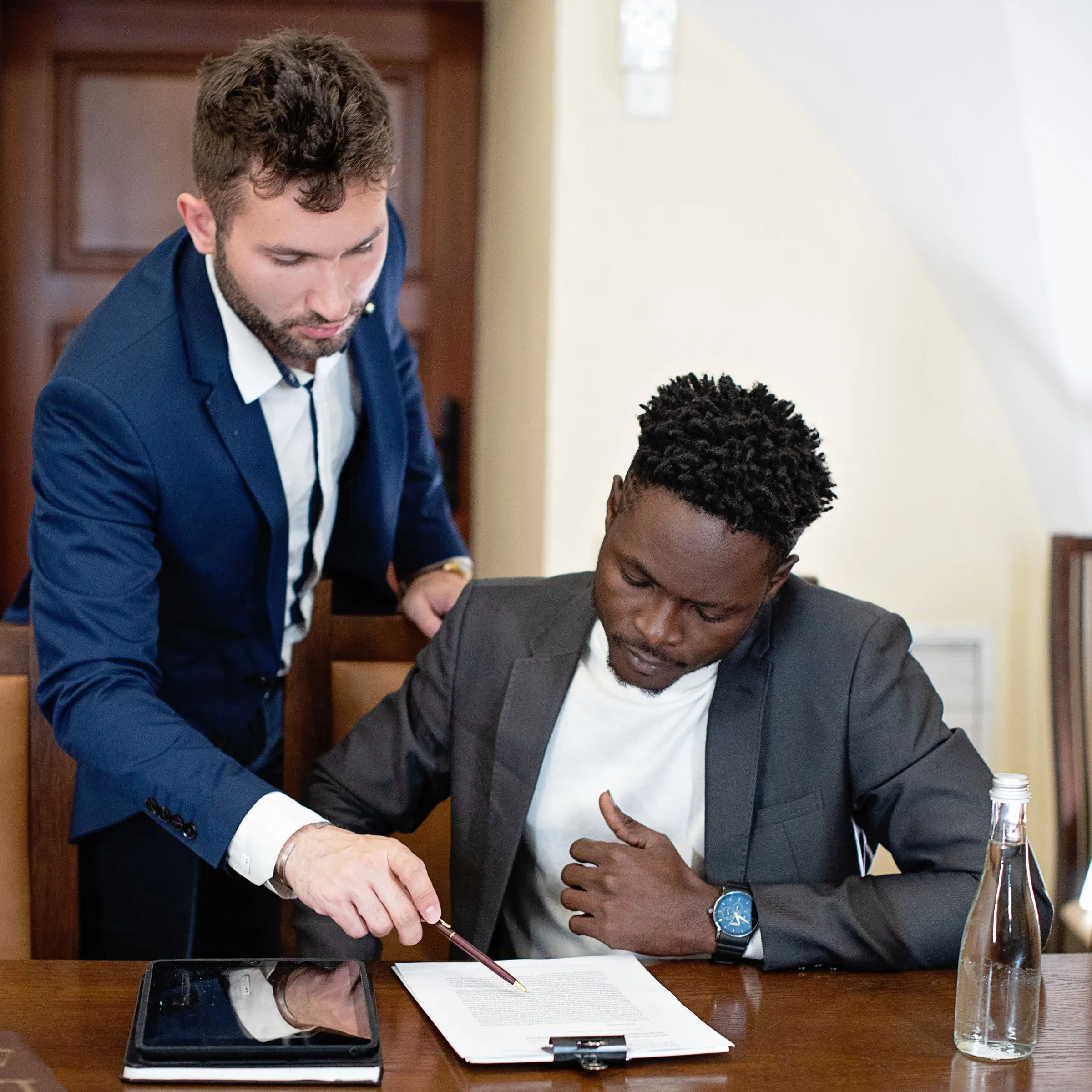 ResolveIt Financials recovery specialists reviewing a client agreement at the office